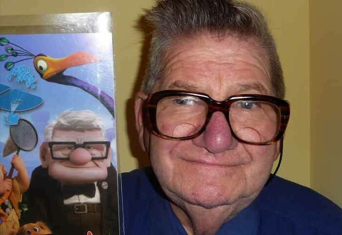 Old man holding a DVD of Up