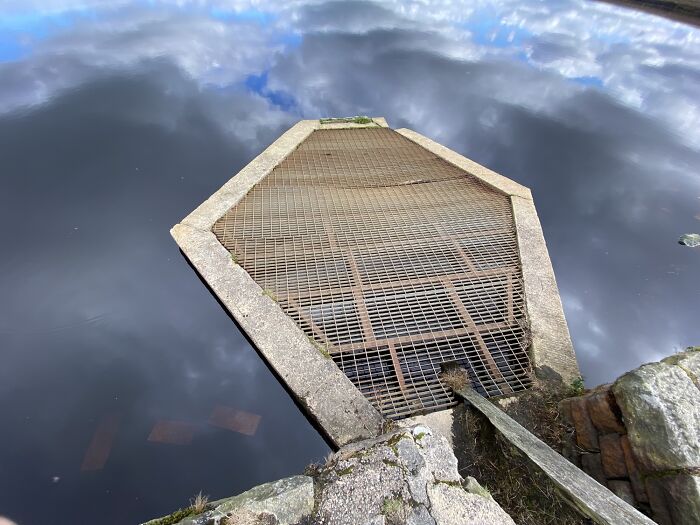 This Unstable Grate Inches Above A Dark Reservoir