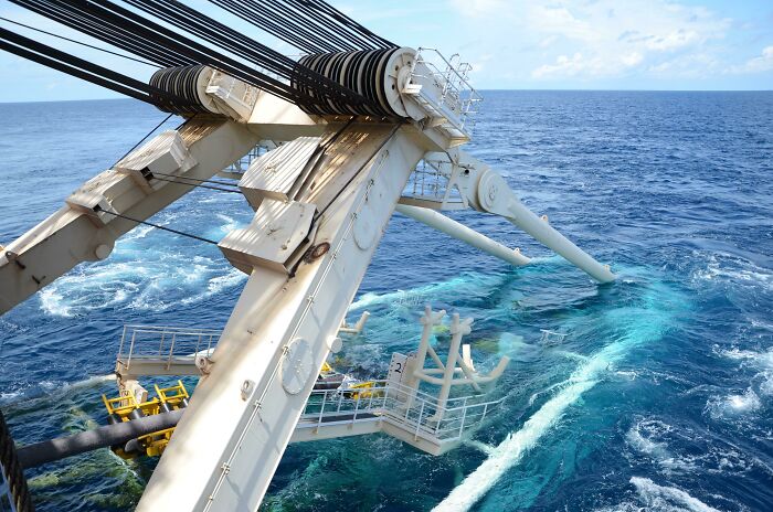 A Ship Lowering A Deep Sea Oil Pipeline
