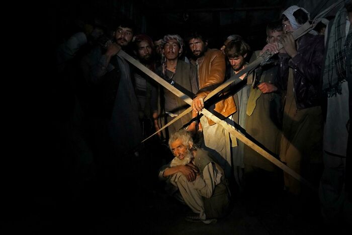 Group Of Men Shelter In The Back Of A Truck