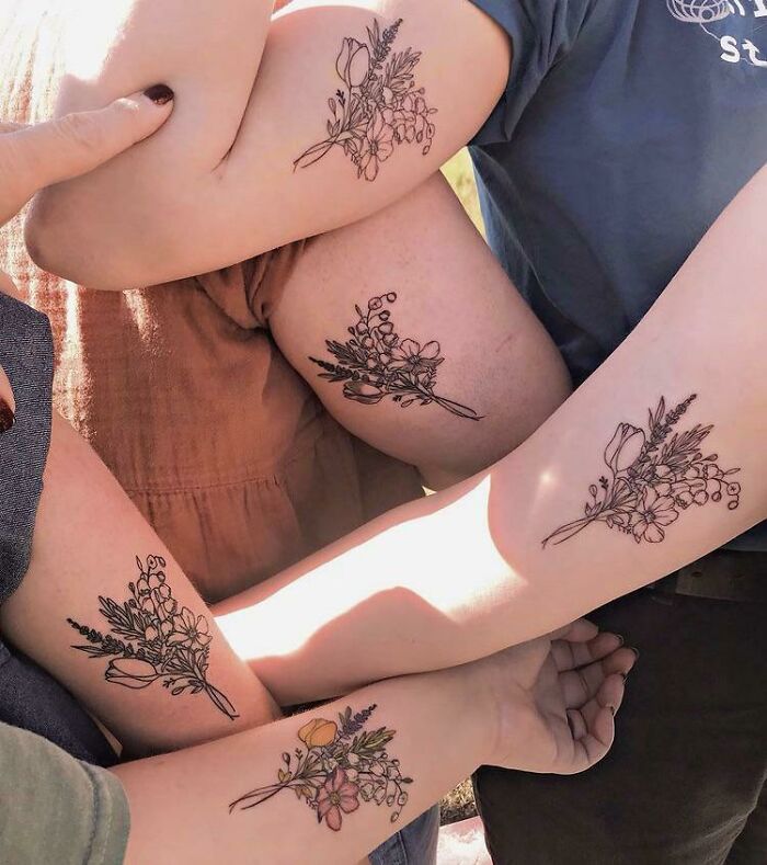 Matching flowers sister arms tattoos