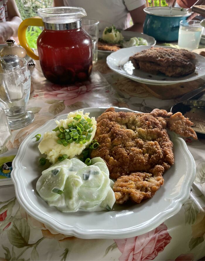 Sunday Lunch In Grandma's Garden In Poland. Pork Chop, Mashed Potatoes, Cucumbers In Sour Cream And Plum Drink
