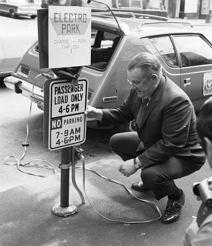 Man Charging An Electric Amc Gremlin. Seattle, USA, 1973