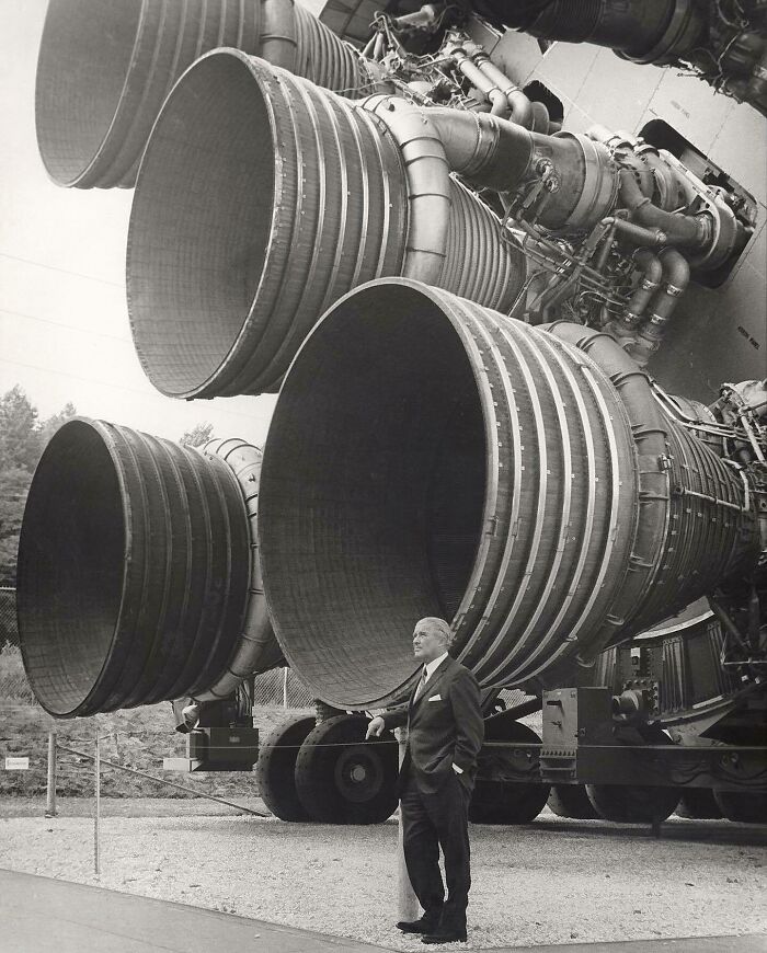 Wernher Von Braun, Designer Of The Saturn V , Poses In Front Of Its Engines (1969). Braun Was The Head Of The German Rocket Industry In World War II. At The End Of The War, He Was Brought To The Us