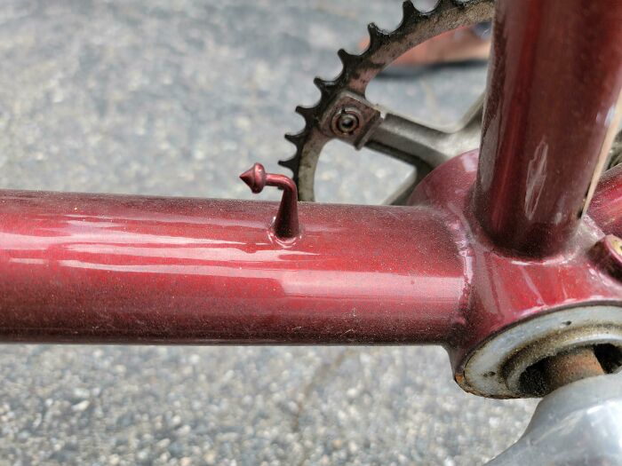 Small Pointy Curved Metal Attached To Bicycle Frame, Point Facing Front Of Bike