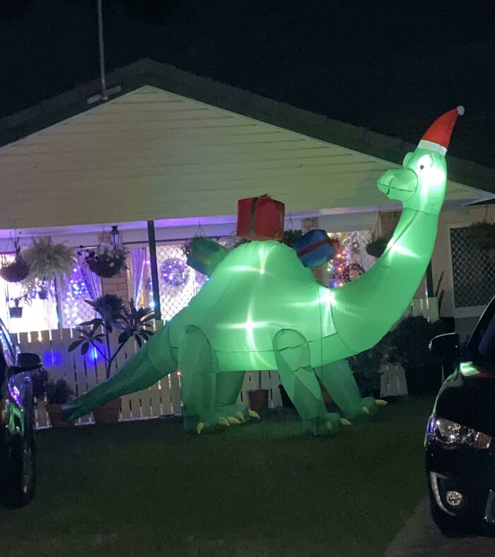 One Of Our Neighbors Has An 11ft Inflatable Christmas Dinosaur In Their Front Yard