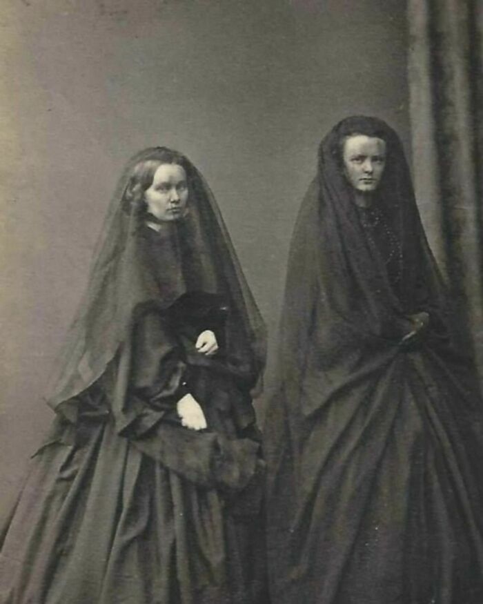 Two Ladies In Mourning Dresses