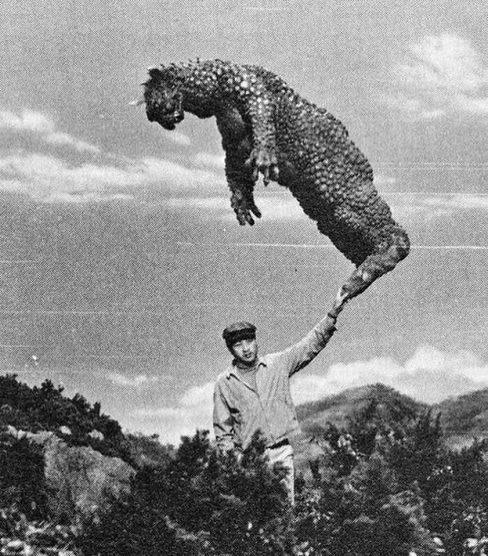 A Man Holding Up The Monster Gabara On The Set Of A Godzilla Movie. This Photo Was Taken Sometime Between 1968 And 1969