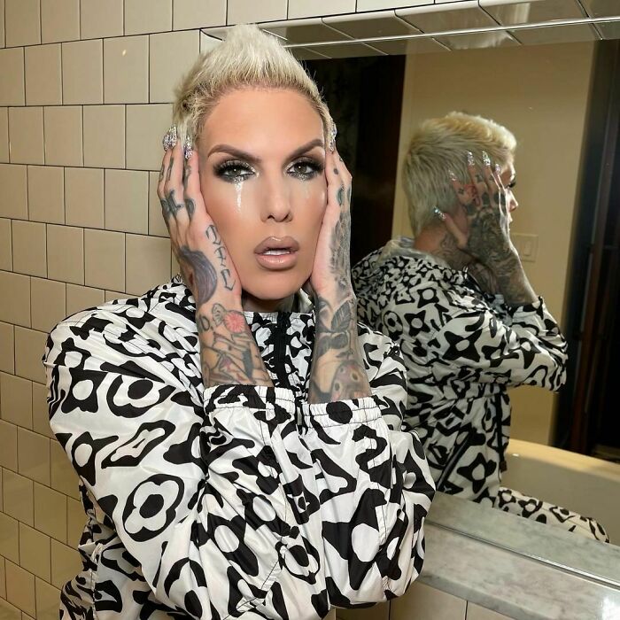 Jeffree Star holding her head and looking