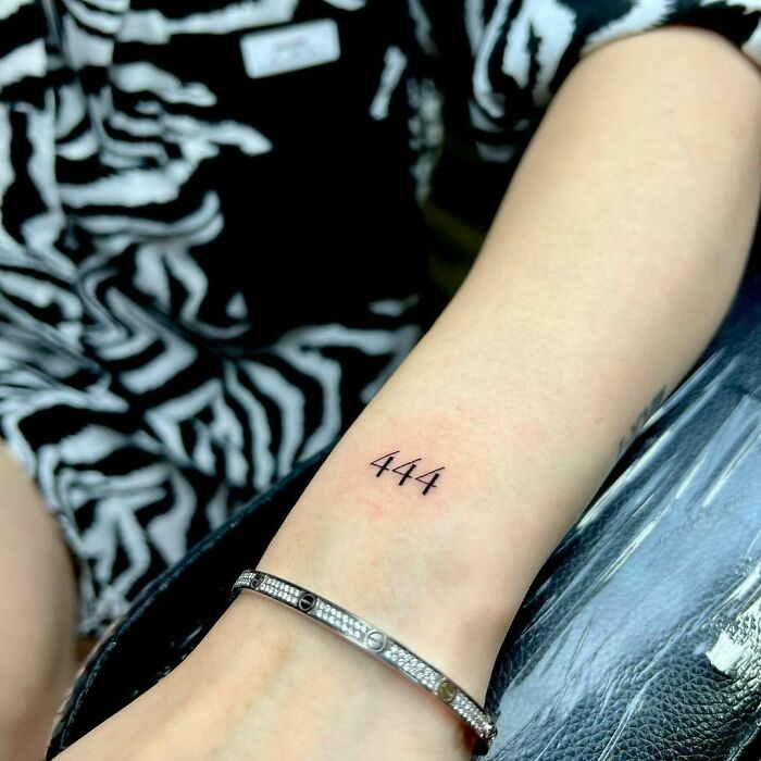 minimalistic tattoo of the number 4 repeated 3 times