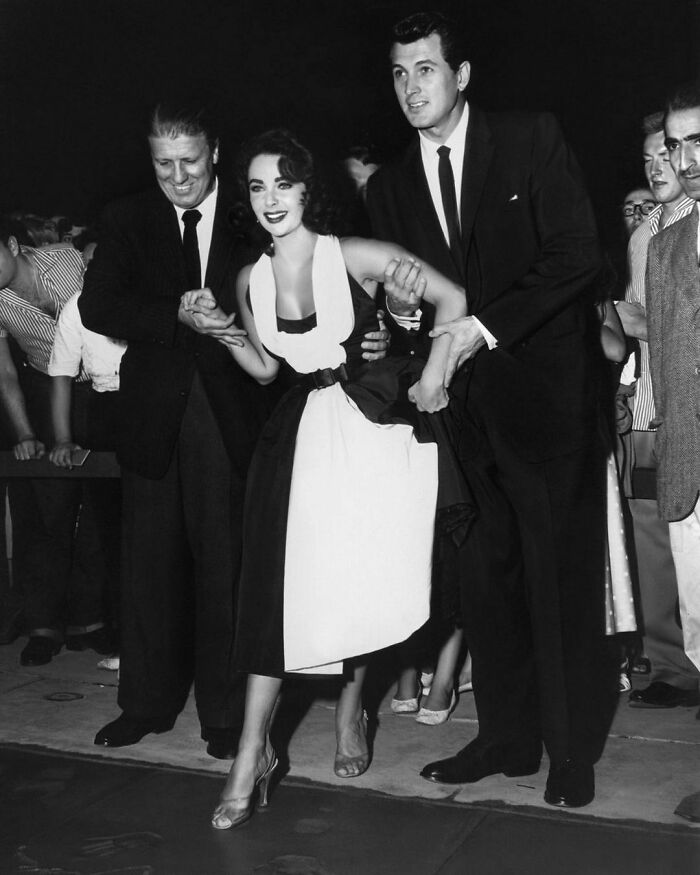 Elizabeth Taylor And Rock Hudson Leaving Their Hand And Foot Imprints At Grauman's Chinese Theatre, 1956. George Stevens, Who Directed Them In Giant, Was Also Present For The Event
