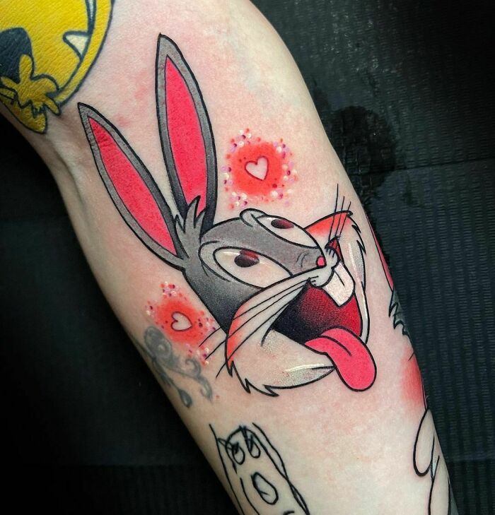 Bugs Bunny arm tattoo with little hearts