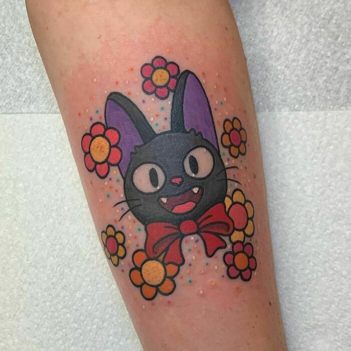 Cute smiling cat with flowers tattoo 