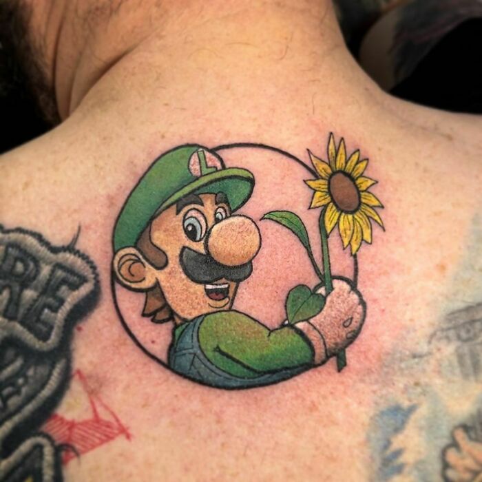 Luigi holding a sunflower back tattoo