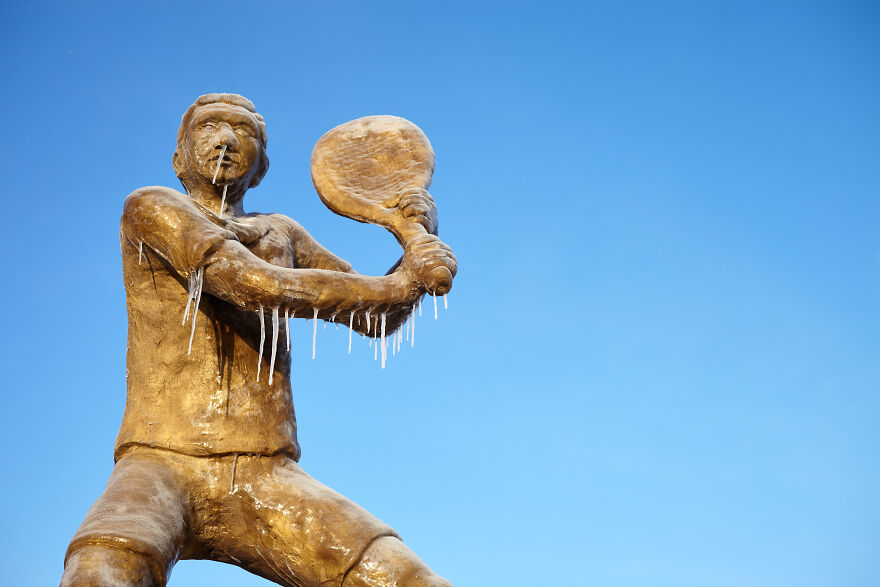 Sculptures Of Athletes Covered With Ice After An Icy Rain