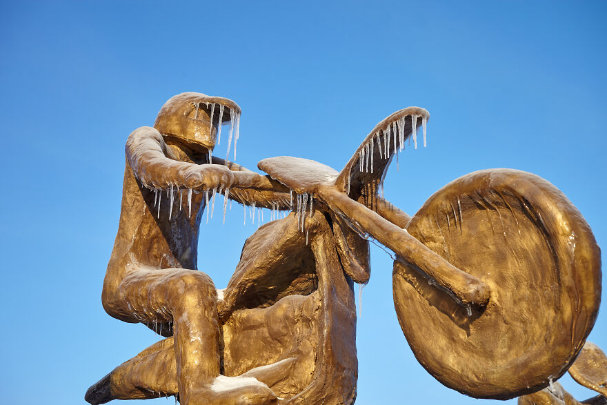 Sculptures Of Athletes Covered With Ice After An Icy Rain
