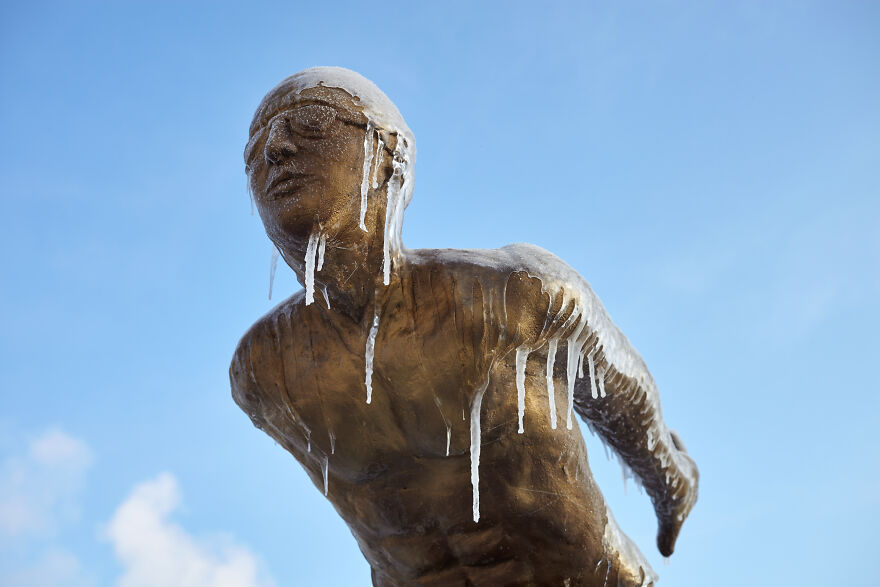 Sculptures Of Athletes Covered With Ice After An Icy Rain
