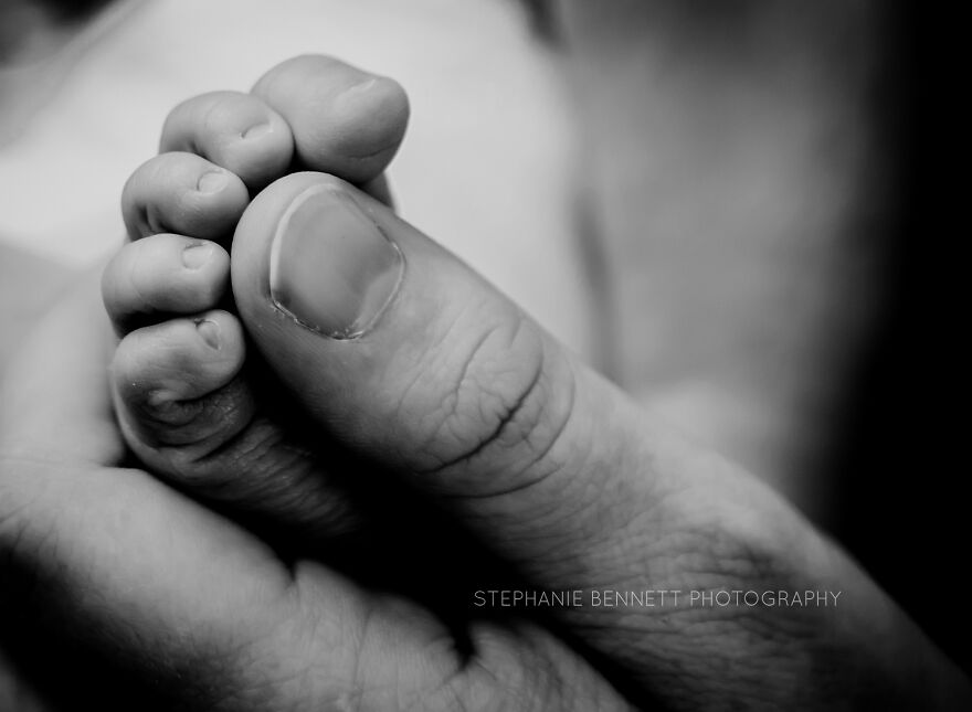 A photograph of a newborn's tiny foot