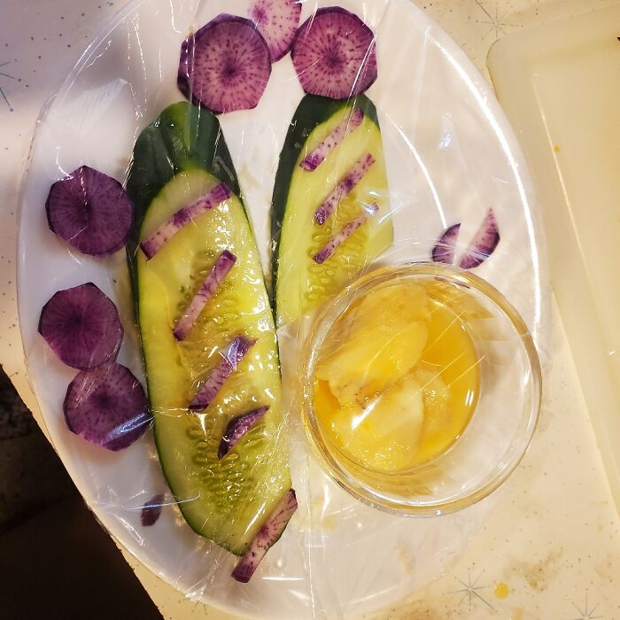 Filet Of Cucumber Topped With Purple Daikon Radish With A Sweet Wine And Fresh Ginger Dressing