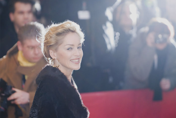 Sharon Stone wearing black clothes and smiling