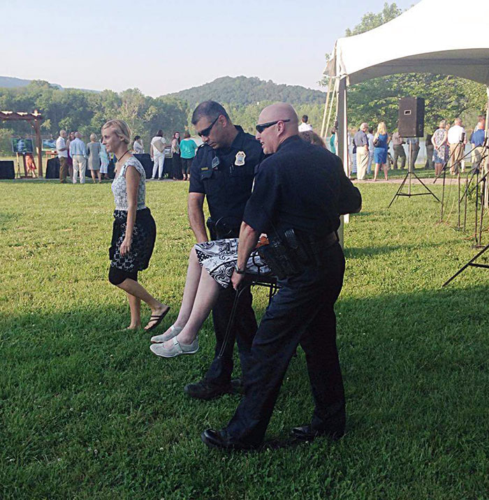 A Woman With Multiple Sclerosis Couldn't Make It To Her Tent At An Event. So Two Chattanooga Police Officers Helped Her Out By Carrying Her To The Place