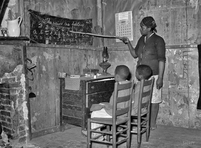 Mother Teaching Children Numbers And Alphabet In Home Of Sharecropper. Transylvania, Louisiana. Jan. 1939