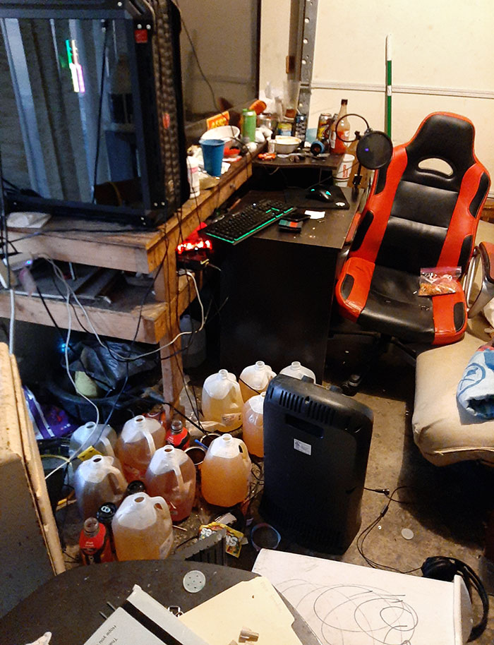 A Friend's Brother Lives In His Garage Trying To Make It Big On Twitch. He Shows Me This Picture Of His "Streamer Den." And Yes, Those Are Gallons Of Urine
