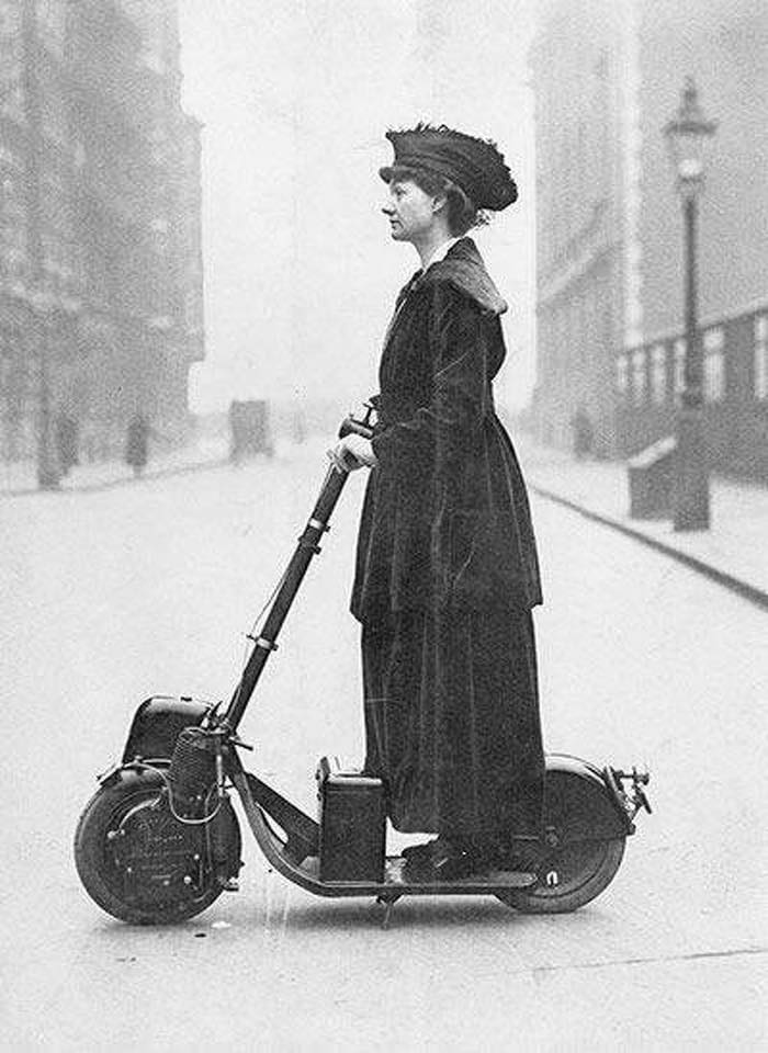 A Woman Riding An Autoped