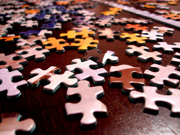 Puzzle Pieces Scattered On The Table 