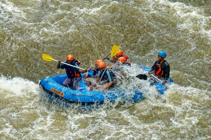 Group Of Friends Water Rafting In A River 