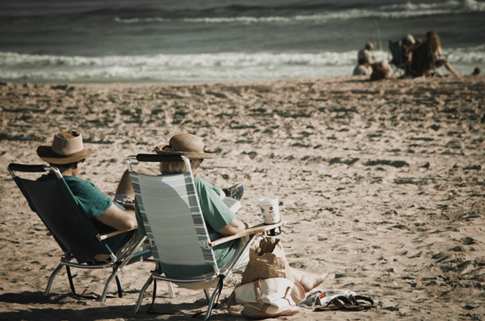Two person sitting in the beach