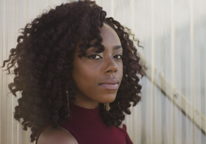 Woman wearing dark red dress looking