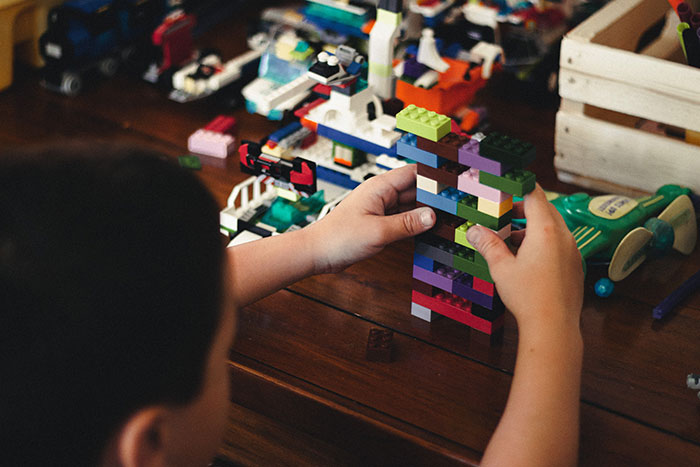 Kid building models from LEGO