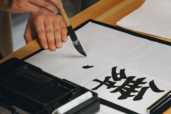 Person writing calligraphy