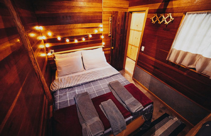 Cozy wooden room with a massive bed 
