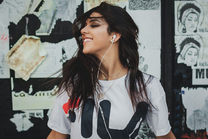 Woman with headphones smiling 