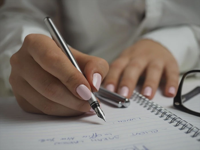 Woman taking notes in a notepad 