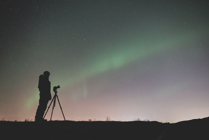 Person spotting northern lights at night 