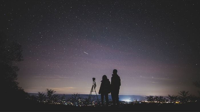Man and woman stargazing 