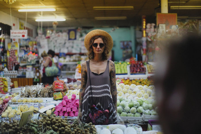 Woman with sunglasses standing in a farmer's market 