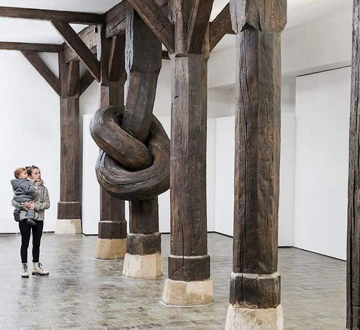 Known For His Mind-Bending Installation Art, Alex Chinneck Has Moved Indoors For His Latest Art Installation, Tying A 450-Year-Old Wood Column Into A Knot