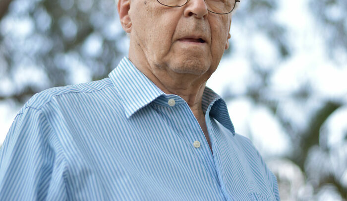 man wearing blue shirt and glasses 