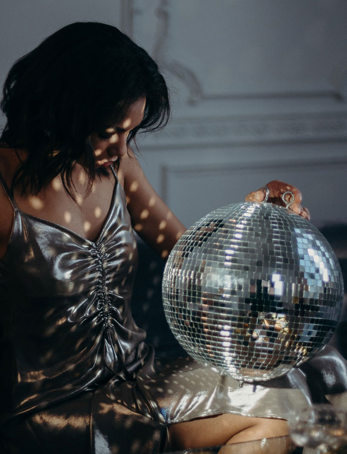woman holding a disco ball