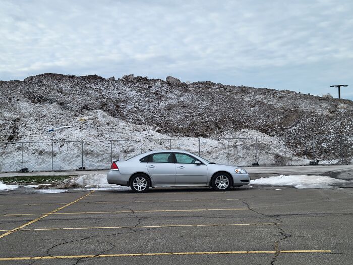 That *mountain* Is Snow Plowed Into A Parking Lot. 8ft Fence For Scale