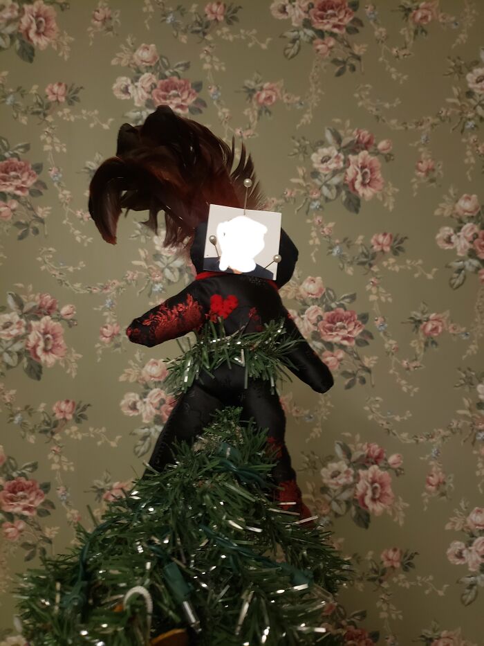 This Year, We Have A Vudu Doll With A Picture Of My Grandfather Pinned To It As The Tree Topper
