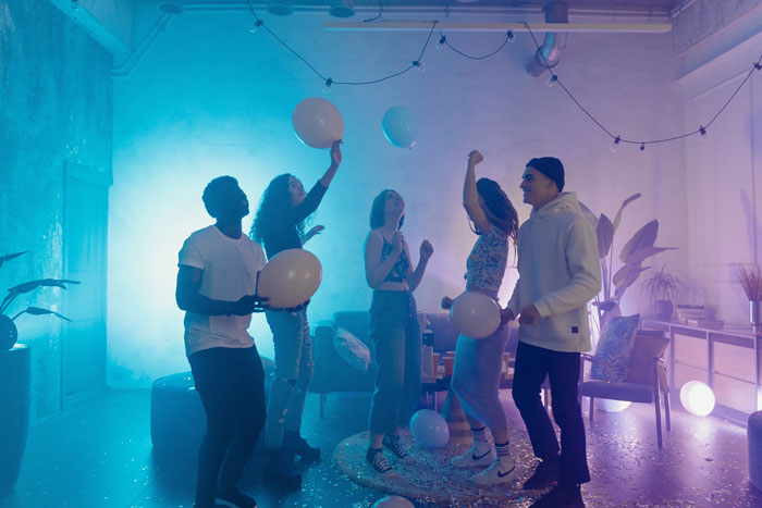 a group of people dancing with balloons
