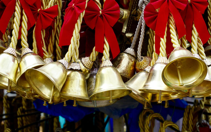a golden bells with red bows