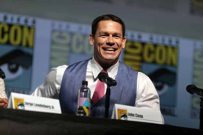 John Cena speaking at a panel, showcasing one of the smartest celebrities known for talent and intelligence.
