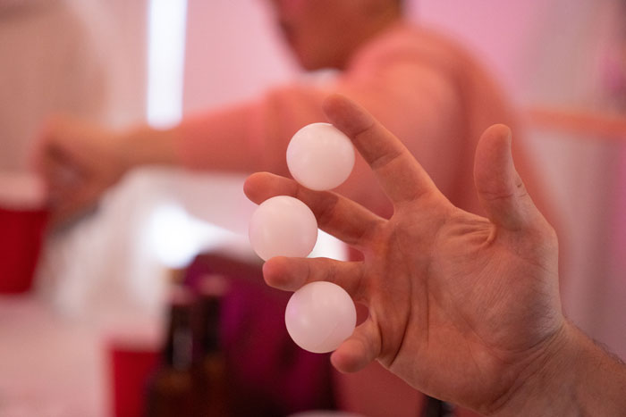 three plastic balls in a human's fingers