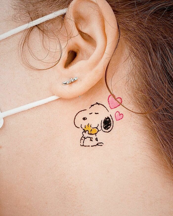 Snoopy and Woodstockher hugging ear tattoo